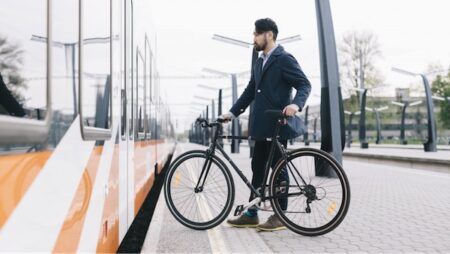 visit estonia 1 253385 man getting on train with bike min.1732266191