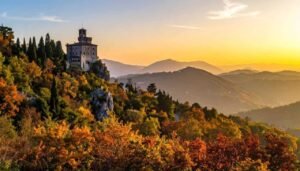Castelo medieval em meio às cores do outono nas montanhas, panorama deslumbrante na Toscana, Itália, ao pôr do sol, viagem de turismo, destino europeu, natureza e história.