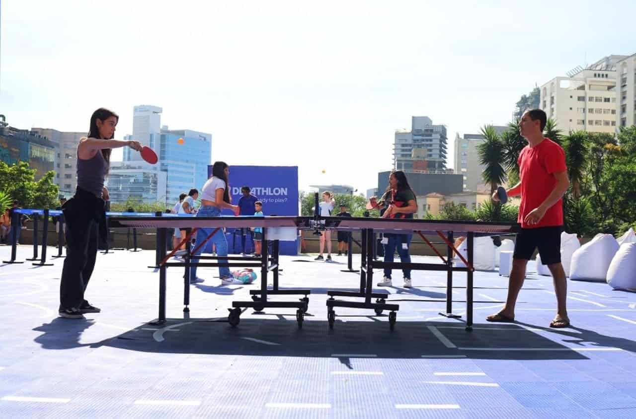 SuoViaggio esporta diversão ao ar livre com pessoas jogando pingue-pongue em ambiente urbano e com clima ensolarado, promovendo eventos de lazer e integração nas cidades brasileiras.